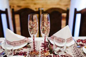 Two glasses of champagne on an old rustic wooden table. Vintage wedding table decoration.