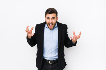 Young caucasian business man against a white background isolated screaming with rage.
