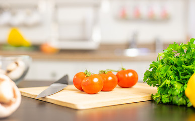 Ripe cherry tomatoes on kitchen table.