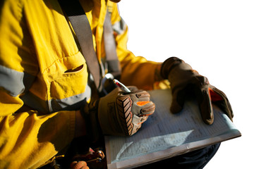 Construction miner supervisor wearing  safety glove signing working at height working permit on open field job site prior to starting high risk work each shift isolated white background 