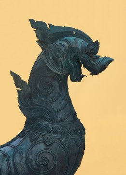 Bronze statue of a Singha guardian lion, one the many leogryphs (lion-like creatures) of asian and buddhist mythology. This one is located in Wat Benchamabophit temple, in Bangkok, Thailand.