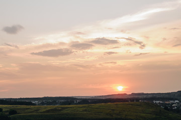 Naklejka na ściany i meble Beautiful sunset. The view from the hill.