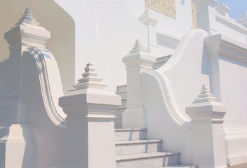 White stucco stairway at a buddhist temple in Bangkok, Thailand.