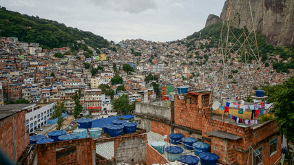 Rocinha is the largest favela in Brazil, located in Rio de Janeiro's South Zone between the...