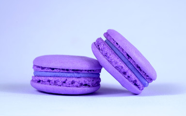 .violet macaroons on a violet background close-up