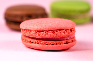 pink macaroon on a pink background close-up