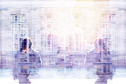 Abstract digital composite of city background photo over man and woman silhouettes walking in front of old vintage French parisian windows