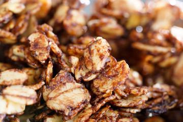 Macro shot of homemade cocoa granola with crunchy peanuts and maple syrup. Morning light, high resolution