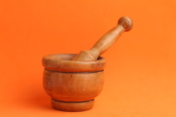cooking wooden mortar in color background