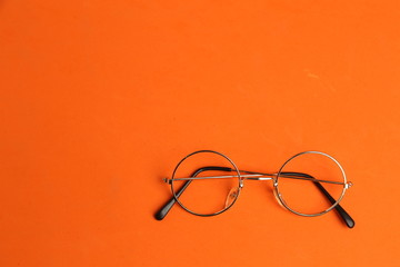 glasses with round crystals on colored background