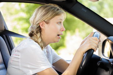 a female sneezing while driving