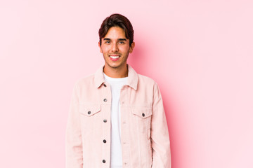 Young caucasian man posing in a pink background isolated happy, smiling and cheerful.