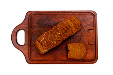 Top view of fresh sliced wholegrain or multi grain bread on dark ructic wooden background, close up.