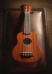 Fototapeta na wymiar ukulele on a piano chair