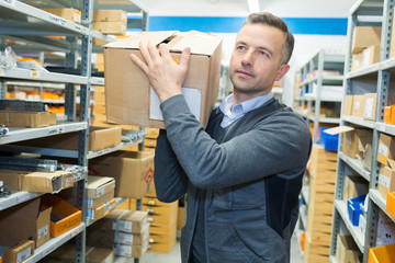 warehouse man carrying boxes