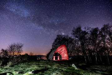 Milky way in the beautiful illuminated hermitage of Agiña, Navarra