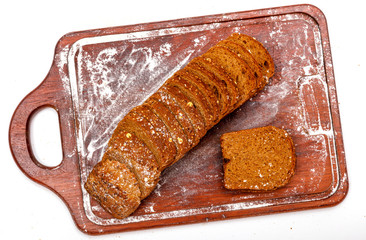 Top view of fresh sliced wholegrain or multi grain bread on dark ructic wooden background, close up.