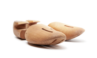 Selective focus of men's wooden shoe stretcher isolated on a white
