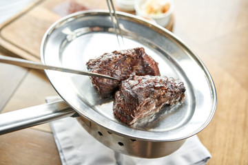 Various grilled meat set with Pickled cabbage and two sauces. Serving on a wooden Board. Barbecue restaurant menu, a series of photos of different meats.