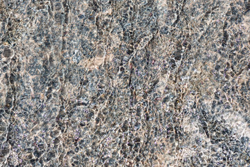 water flowing down from a blue stone closeup. Background for bathroom tiles