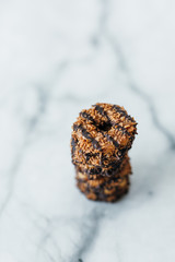 Stack of coconut and chocolate cookies on marble
