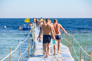 People walk on a plastic pontoone