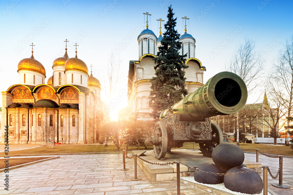 Wall mural spring kremlin in moscow city russia landmark with tsar cannon monument street view against old orthodox church in setting sunlight background. Old town cityscape. Tourist attraction. World heritage