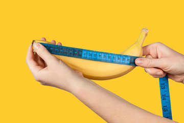 Measuring the size of a banana as a symbol of the male penis. Big dick length. Strong erection and...