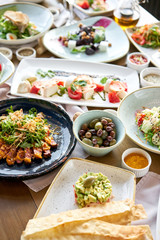 Many different delicious dishes dishes on the table. Various snacks and antipasti on the table. Restaurant menu. Italian cuisine