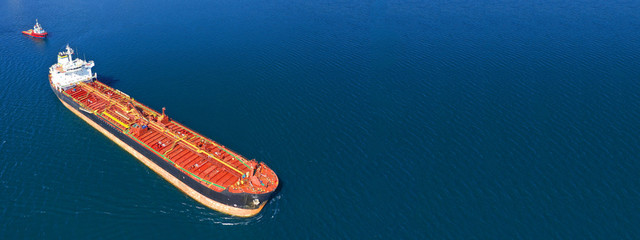 Aerial drone ultra wide photo of fuel tanker ship docked in Mediterranean bay