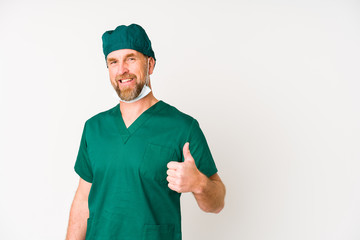 Surgeon senior man isolated on white background smiling and raising thumb up