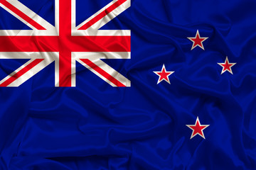 beautiful photograph of the New Zealand national flag on delicate shiny silk with soft draperies, the concept of state power, country life, horizontal, close-up, copy space