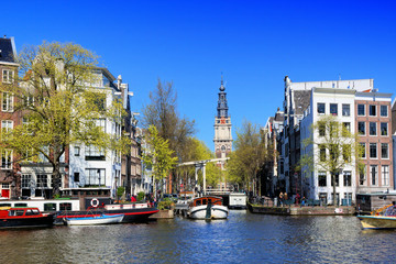 Scenic architecture of Amsterdam with canal houses, lifting bridge and old clock tower, Netherlands