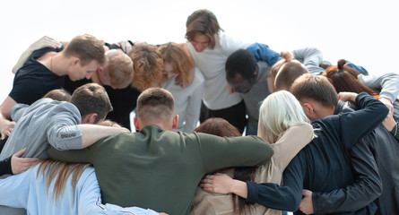 group of young like-minded people standing in a circle.