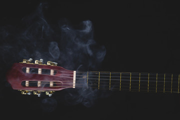 Guitar headstock on black background. acoustic musical instrument