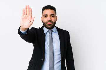 Young latin business woman against a white background isolated standing with outstretched hand showing stop sign, preventing you.