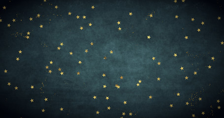 golden star confetti on dark background backdrop