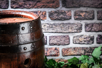 Obraz premium Old beer barrel background and rustic dark brick texture.