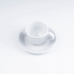 Fototapeta na wymiar Small white coffee cup on a white background.