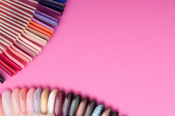 color samplers of gel polish on nail tips on a pink background. save space