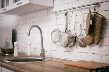 Fototapeta na wymiar faucet and kitchen tools close-up