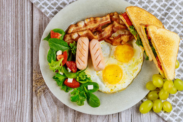 Healty breakfast with egg, salad, grape and grilled cheese toast.