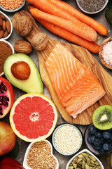 Healthy food clean eating selection: fish, fruit, vegetable, cereal, leaf vegetable on rustic background