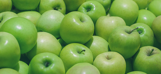 many ripe green apples in a pile