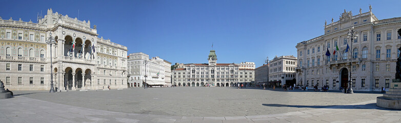 Fototapeta na wymiar Panoramic photo of Piazza Unita di Italia (Unity of Italy Square) Large square in Trieste, Italy. A seaport city in northeast Italy. Unrecognizable people / tourists