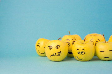 different emotions from joy to sadness and anger Face on an apple - abstract image of human...