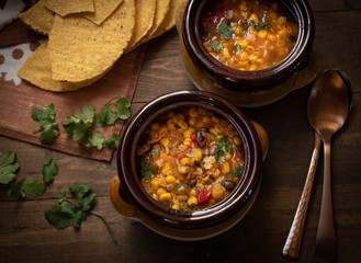 Vegan Mexican soup made with corn, pasta,black beans, green chiles. Served in clay pots