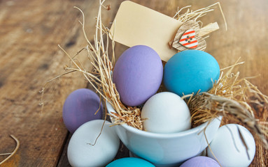 colored Easter eggs in nest top view background, selective focus image. Happy Easter card