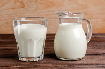Homemade fermented beverage in a glass of kefir on a wooden background