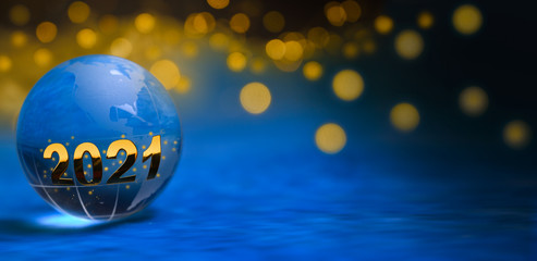 2021 glass globe in front of golden lights and blue background